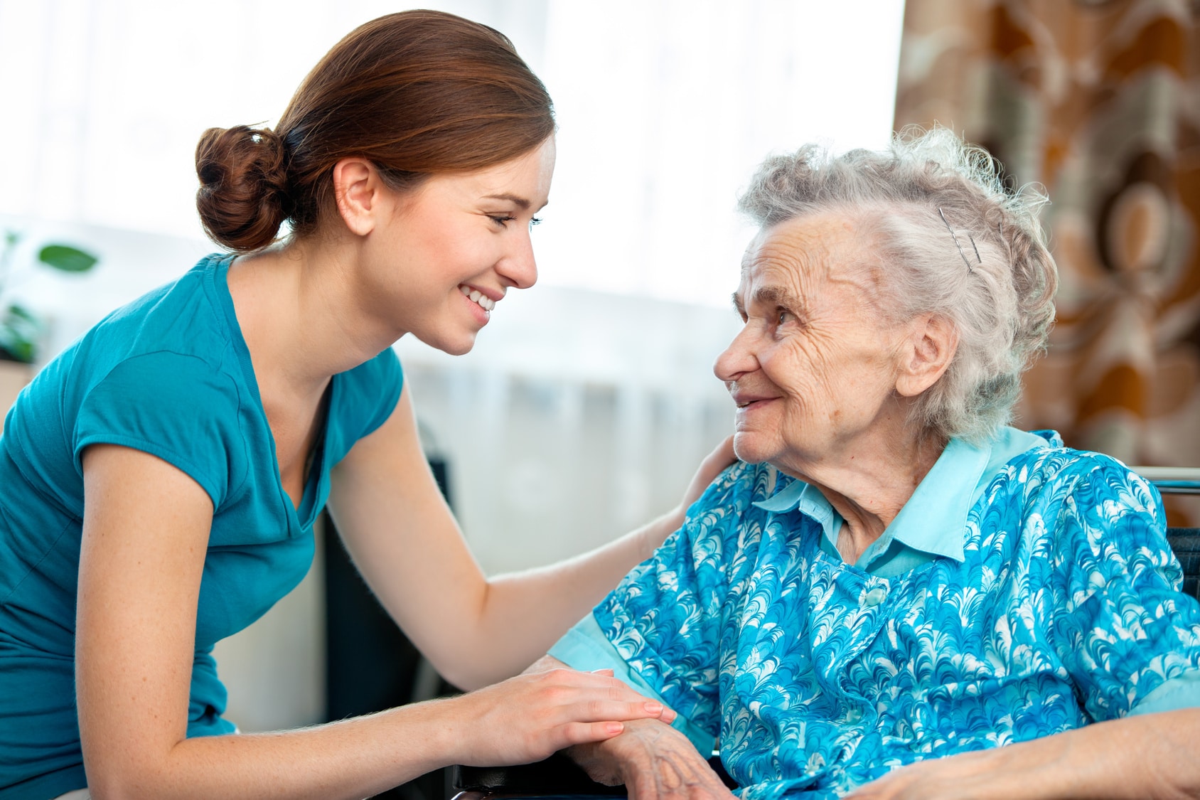 Volunteer talking to older woman